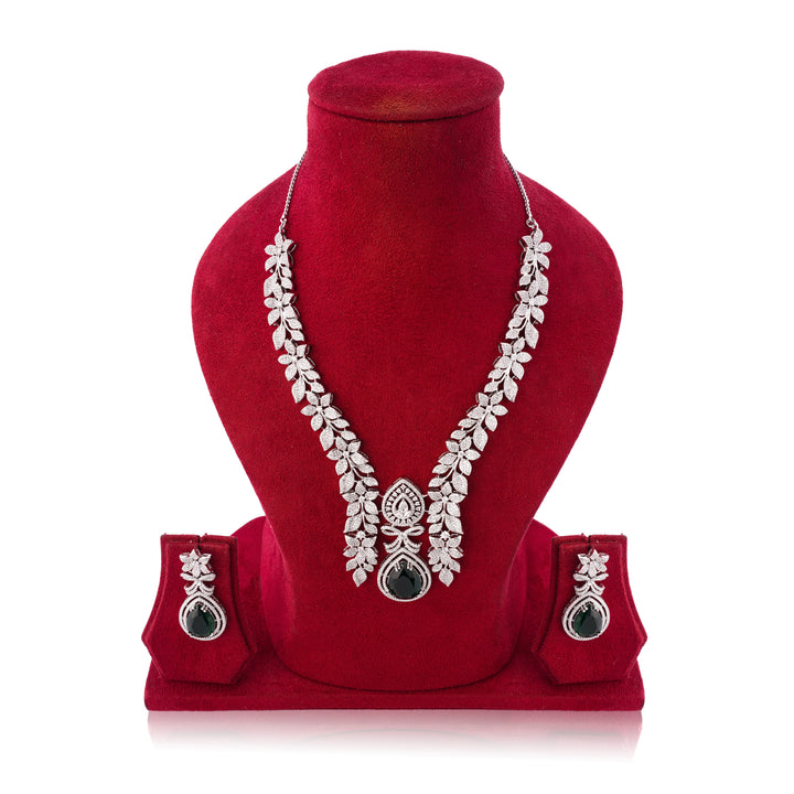 Jewelry set with necklace and earrings on a red velvet stand against a white background