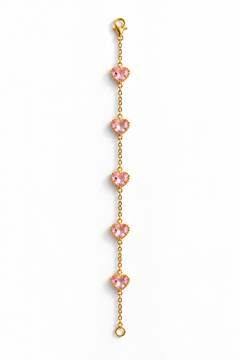 A delicate gold chain bracelet featuring five evenly spaced, heart-shaped pink gemstones, displayed vertically on a clean white background.