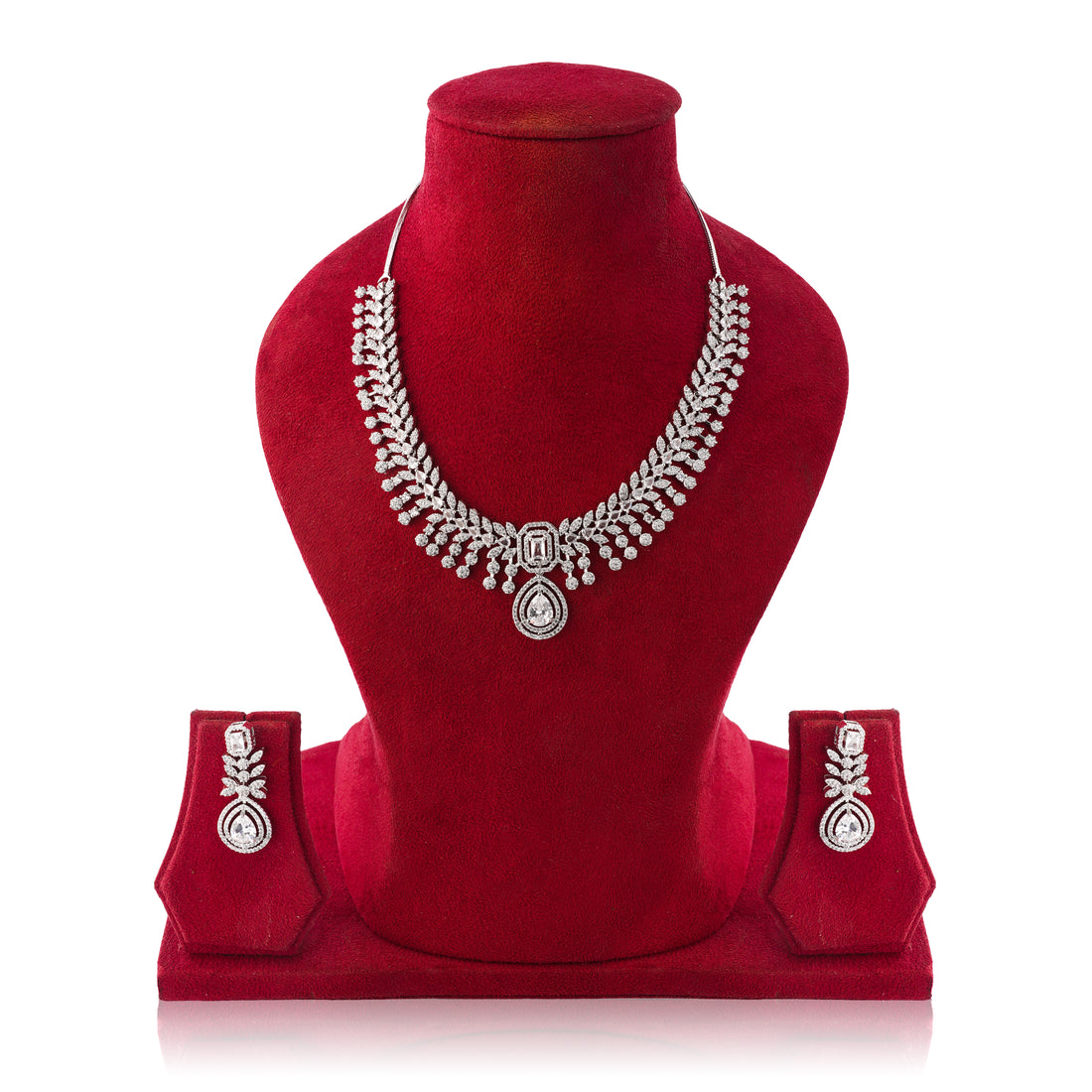 Silver necklace and earrings set on a red velvet mannequin with a white background