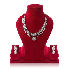 Silver necklace and earrings set on a red velvet mannequin with a white background