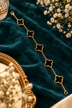 Amaita demi-fine black four-leaf clover charm bracelet with gold finish