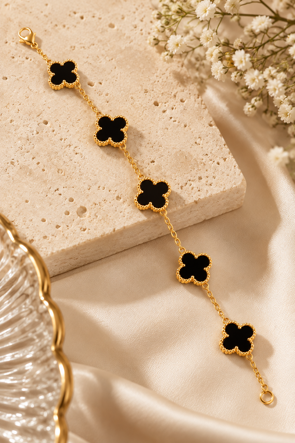 Amaita demi-fine black four-leaf clover charm bracelet with gold finish