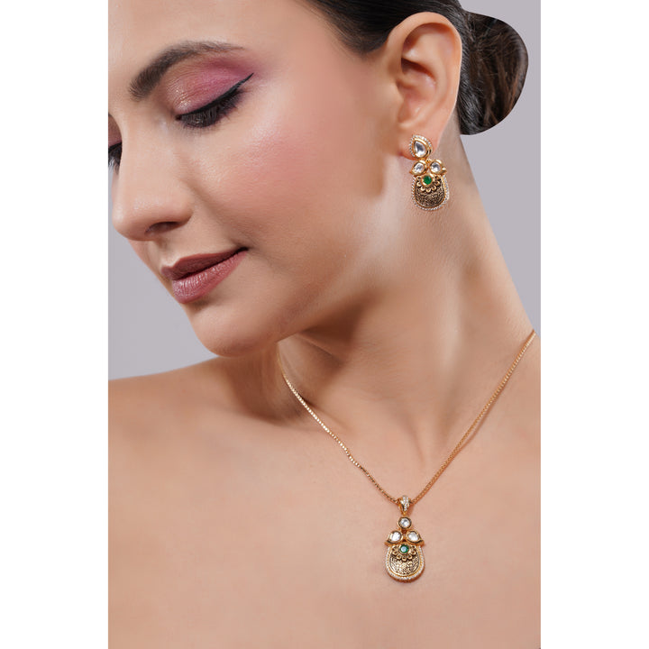 Close-up of a woman wearing gold earrings and necklace with gemstones on a neutral background