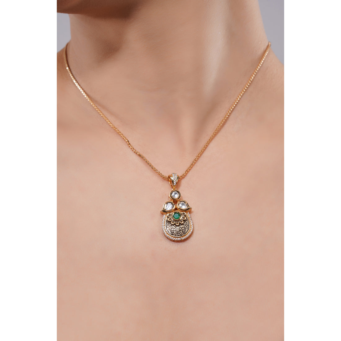 Rose gold necklace with a pendant on a mannequin neck