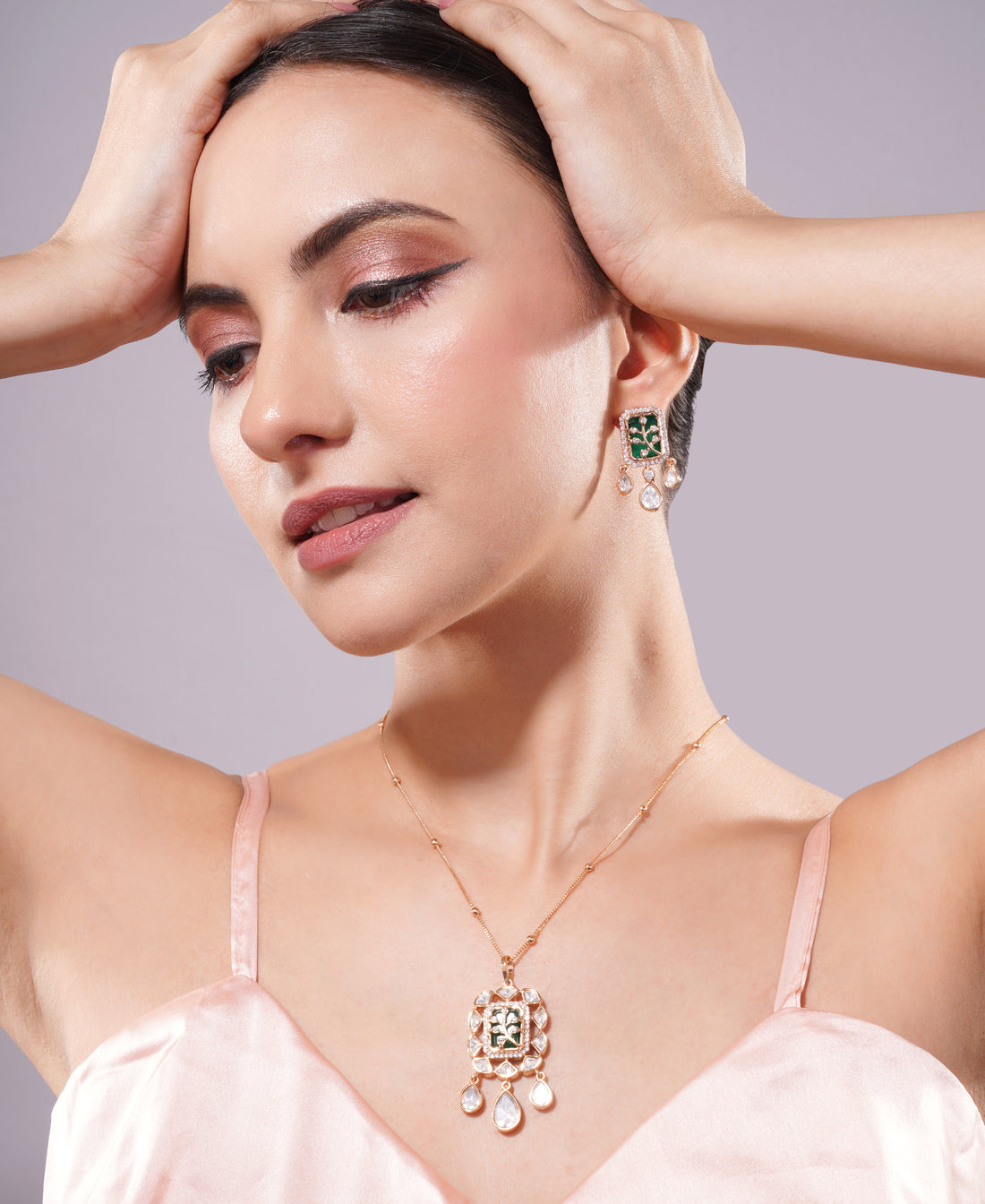 Woman wearing a necklace and earrings against a plain background, jewellery set, pendant with chain, pendant set, pendants