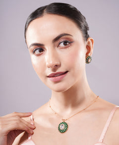 Woman wearing a necklace and earrings with a gray background