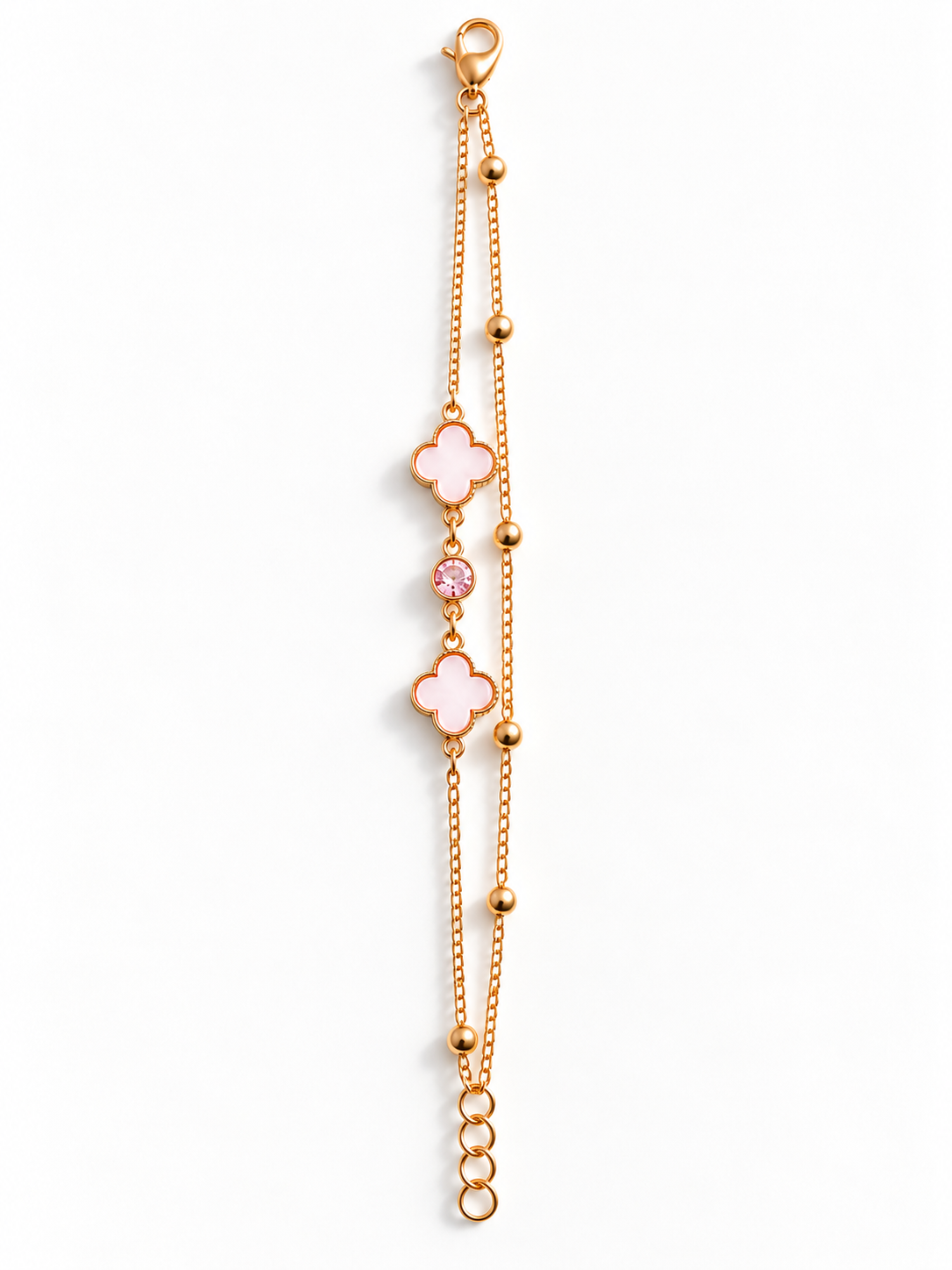 A delicate rose gold chain bracelet featuring two pink enameled clover motifs and a small pink gemstone accent, displayed on a clean white background.