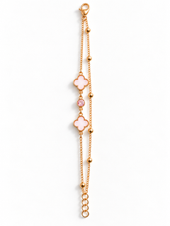 A delicate rose gold chain bracelet featuring two pink enameled clover motifs and a small pink gemstone accent, displayed on a clean white background.
