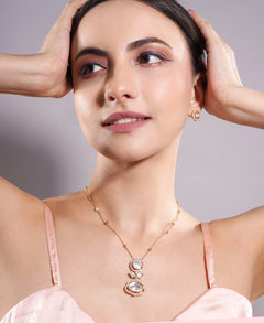 Woman wearing a necklace with a gray background