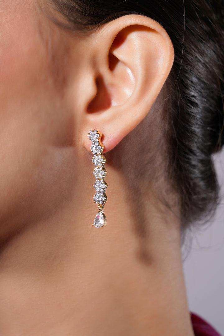 Close-up of a person wearing a diamond earring with a blurred background
