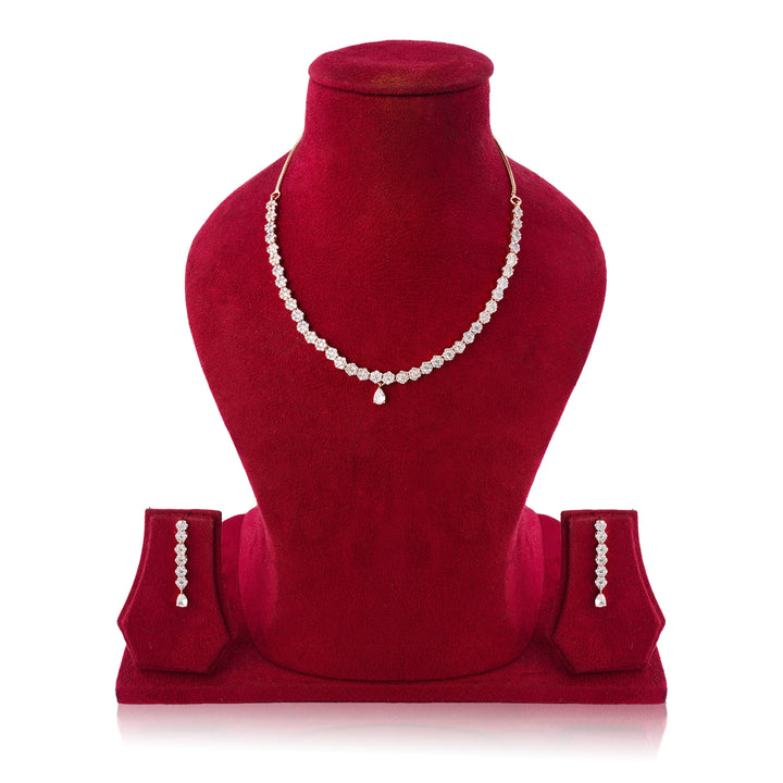 Red velvet jewelry display with a necklace and earrings on a white background