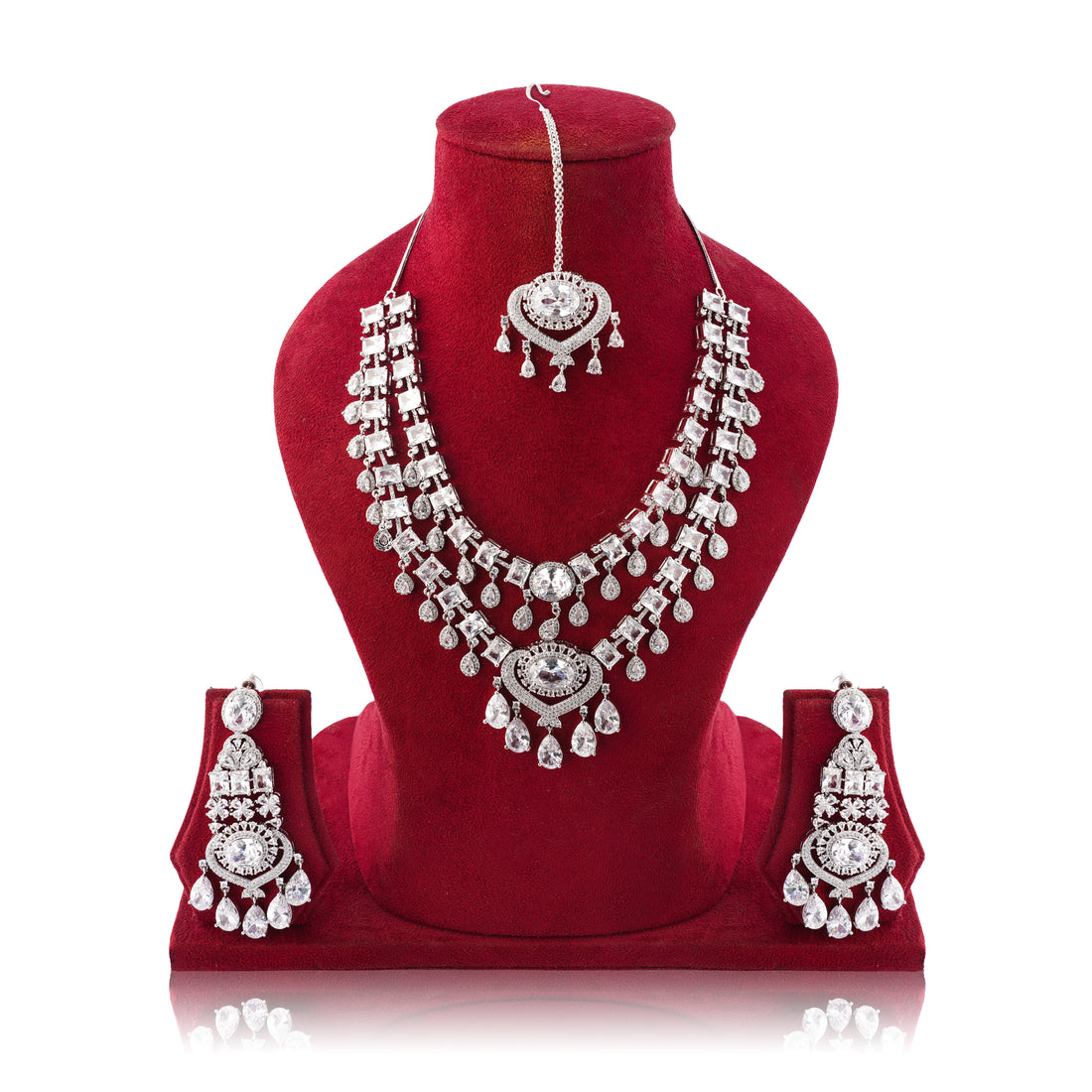 Silver jewelry set with necklace, earrings, and headpiece on a red velvet stand.