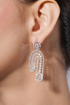 Close-up of a woman's ear wearing a sparkling earring.
