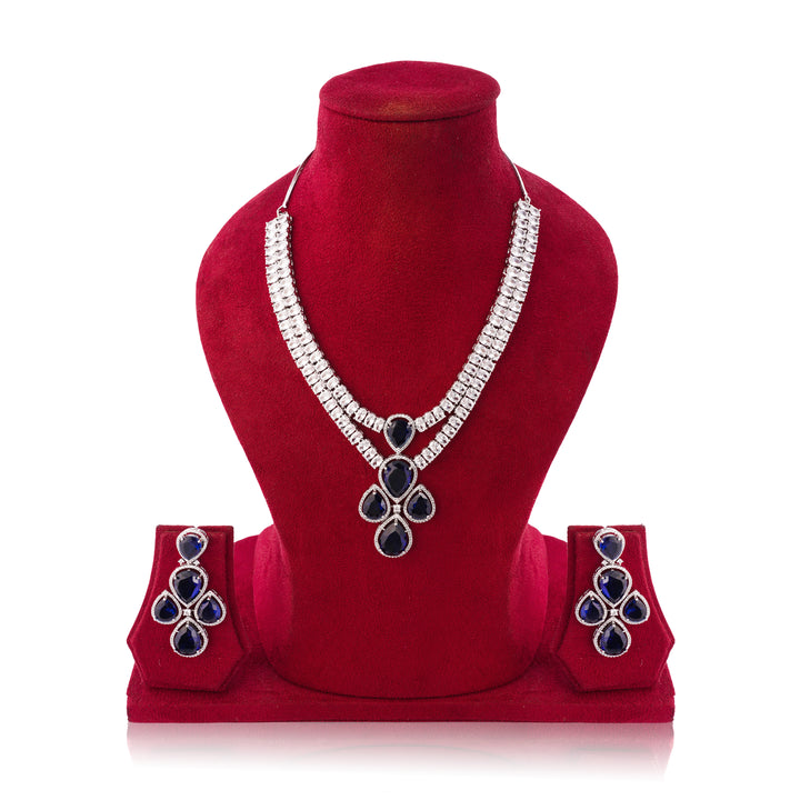 Jewelry set with necklace and earrings on a red velvet stand against a white background