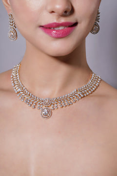 Close-up of a person wearing a sparkling diamond necklace and earrings on a neutral background