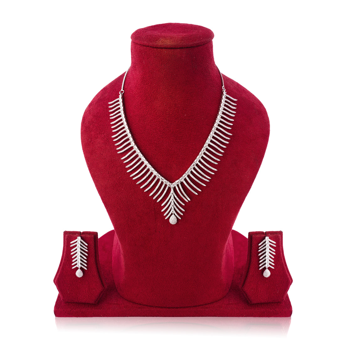 Silver necklace and earrings set on a red mannequin bust with a white background