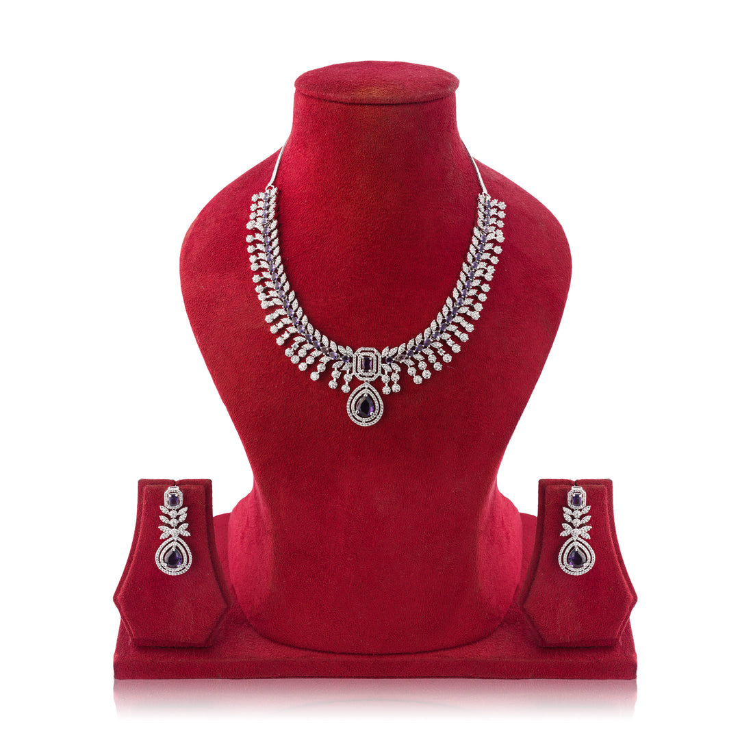 Silver necklace and earrings set on a red mannequin bust with a white background