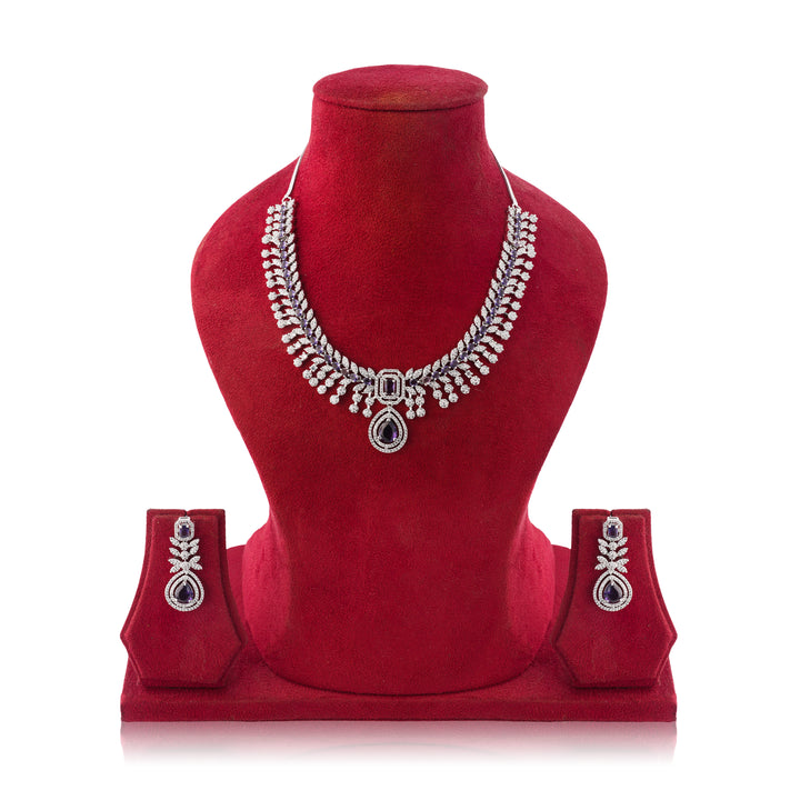Silver necklace and earrings set on a red mannequin bust with a white background