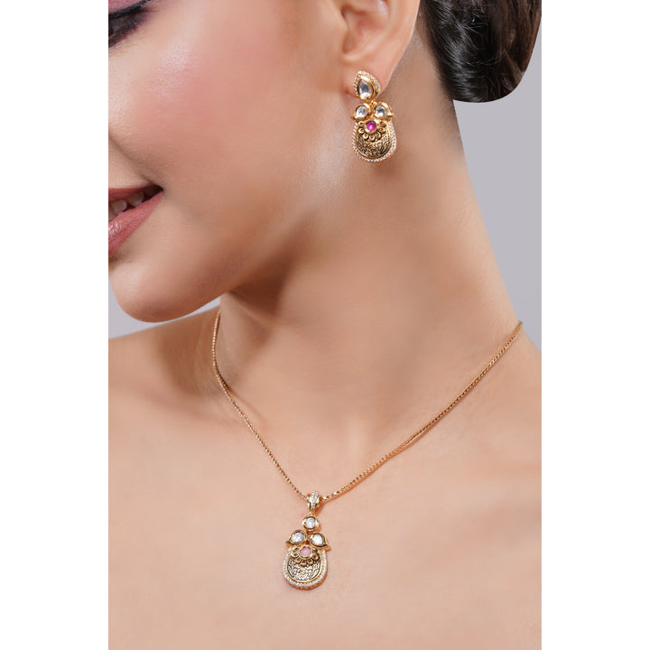 Gold necklace and earrings on a model against a neutral background