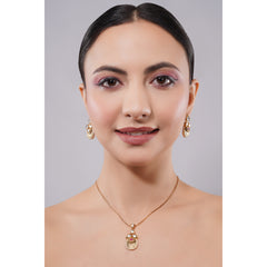 Woman wearing gold jewelry including a necklace and earrings on a gray background