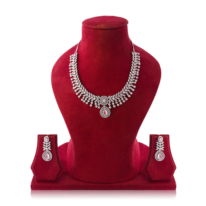 Silver necklace and earrings set on a red mannequin bust with a white background
